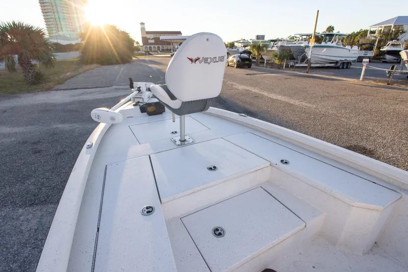 Slide: The Image of 2020 Vexus AVX1980CC boat with white deck, parked near marina at sunset. - 23