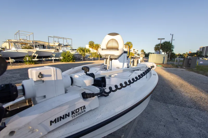 Slide: The Image of 2020 Vexus AVX1980CC boat with Minn Kota Terrova motor in a marina setting. - 25