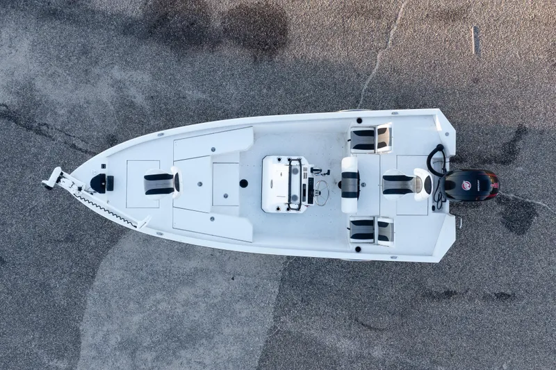 Slide: The Image of Aerial view of 2020 Vexus AVX1980CC boat on pavement, showcasing seating and motor. - 3