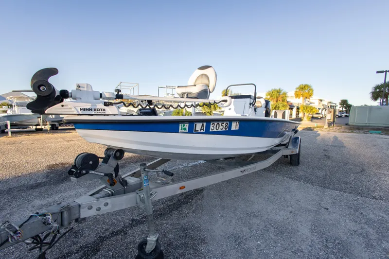 Slide: The Image of 2020 Vexus AVX1980CC boat on trailer with Minn Kota motor in sunny setting. - 6