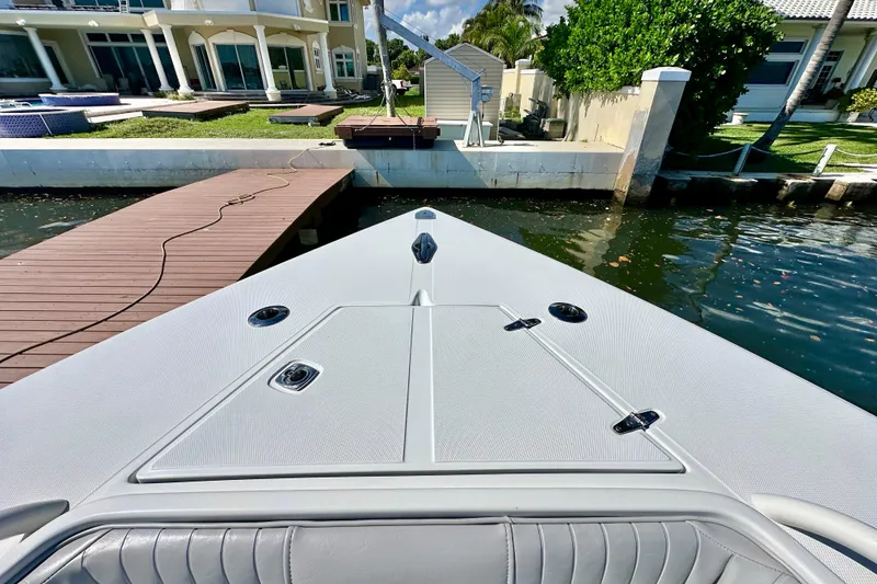 Slide: The Image of Bow view of 2006 Jupiter 31FS boat docked by waterfront home. - 18