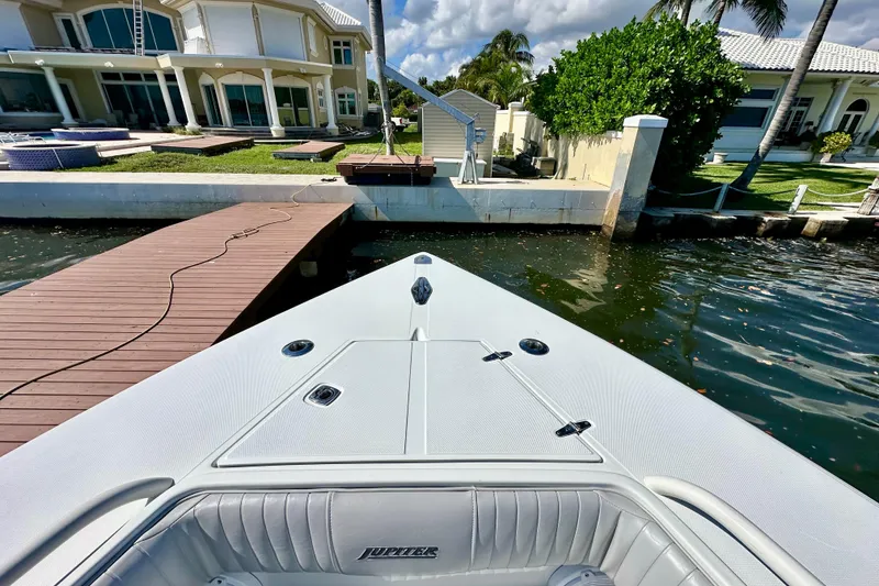 Slide: The Image of 2006 Jupiter 31FS boat docked near luxurious waterfront home. - 19