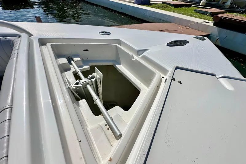 Slide: The Image of Open anchor compartment on 2006 Jupiter 31FS boat docked by the water. - 20