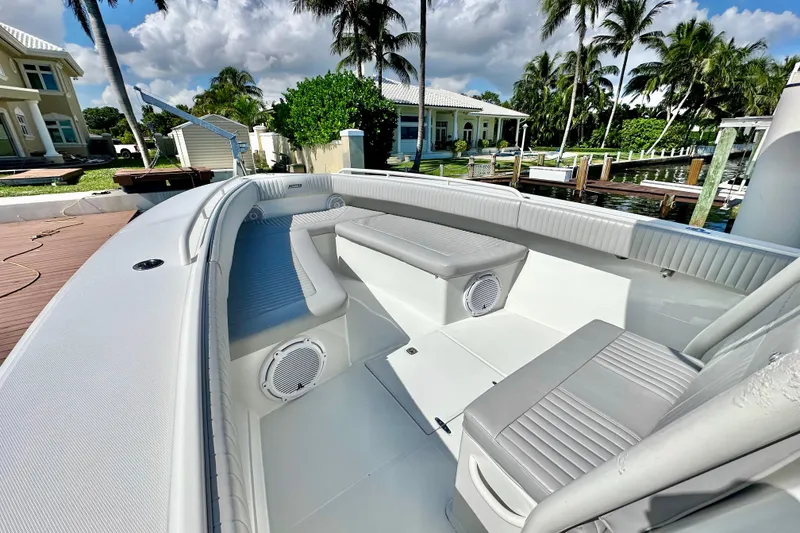 Slide: The Image of 2006 Jupiter 31FS boat interior with seating, docked near waterfront homes and palm trees. - 29