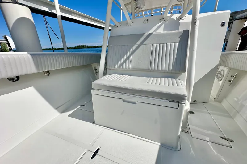 Slide: The Image of 2006 Jupiter 31FS boat interior with white seating and open deck, under clear blue sky. - 34