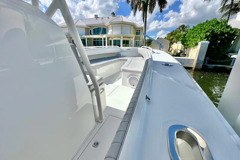 Slide: The Image of 2006 Jupiter 31FS boat docked near waterfront home, under clear blue sky. - 37