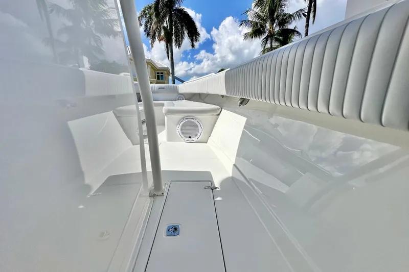 Slide: The Image of 2006 Jupiter 31FS boat interior with white seating and palm trees in the background. - 39