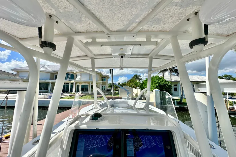 Slide: The Image of 2006 Jupiter 31FS boat docked, featuring a spacious helm and modern navigation equipment. - 46