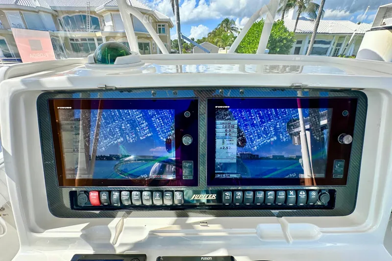 Slide: The Image of Boat dashboard with dual navigation screens on a 2006 Jupiter 31FS. - 51