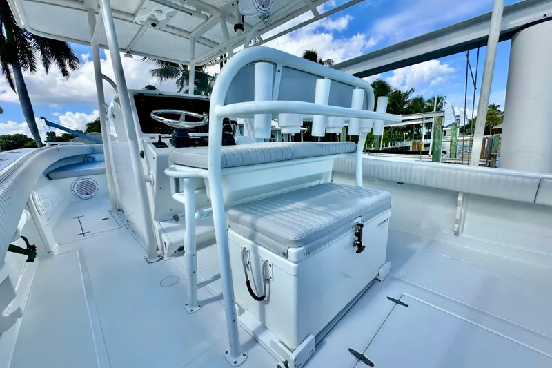 Slide: The Image of 2006 Jupiter 31FS boat interior with seating and steering wheel, under a clear blue sky. - 53