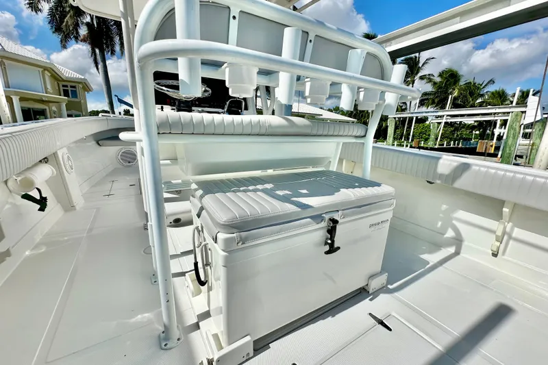 Slide: The Image of 2006 Jupiter 31FS boat interior with seating and storage under sunny skies. - 55