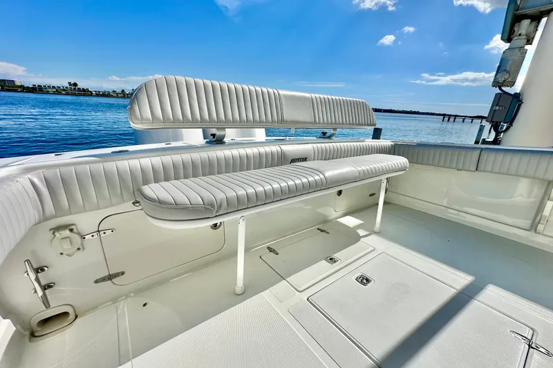 Slide: The Image of 2006 Jupiter 31FS boat interior with cushioned seating, overlooking calm blue waters. - 59