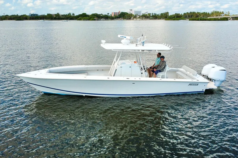 Slide: The Image of 2006 Jupiter 31FS boat on calm water with two people onboard. - 6