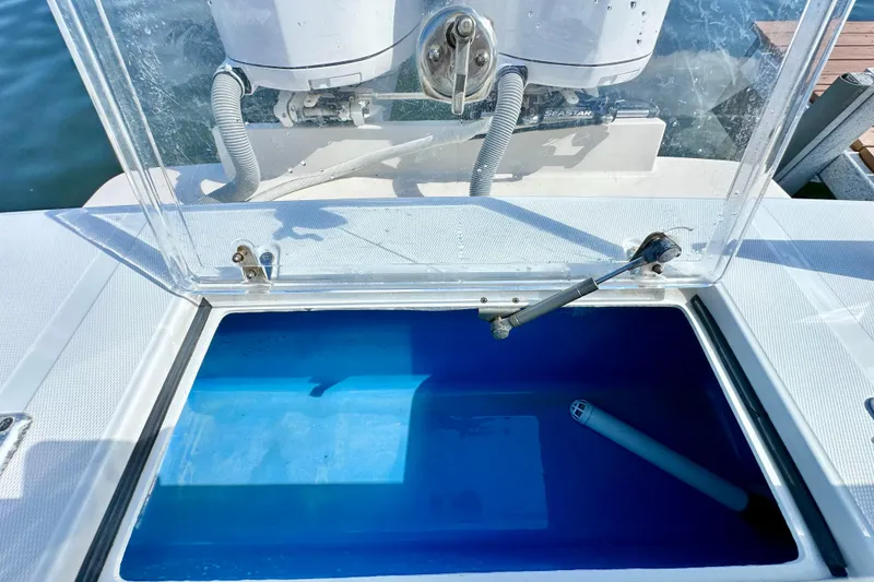 Slide: The Image of Open livewell on 2006 Jupiter 31FS boat with clear lid and blue interior. - 62