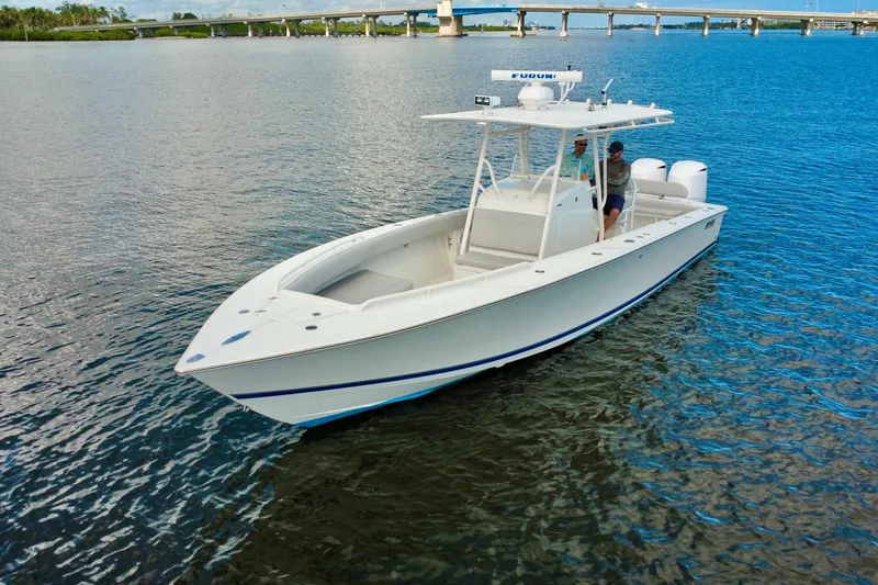 Slide: The Image of 2006 Jupiter 31FS boat on calm water near a bridge. - 7