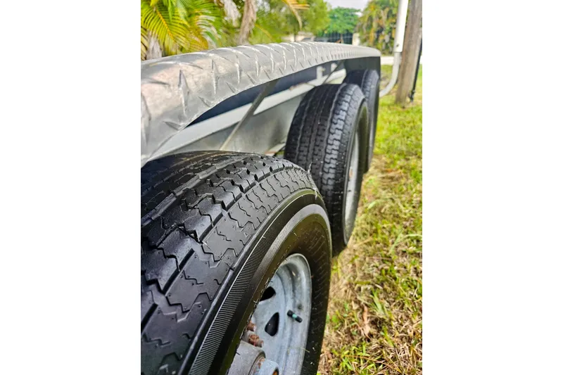 Slide: The Image of Close-up of 2006 Jupiter 31FS trailer tires on grass, showcasing tread detail. - 76
