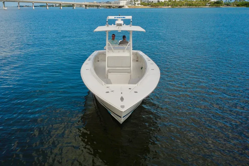 Slide: The Image of 2006 Jupiter 31FS boat on calm water with bridge in background. - 8
