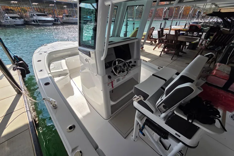 Slide: The Image of 2026 Blackfin 262 HB boat interior at marina, featuring helm and seating area. - 10