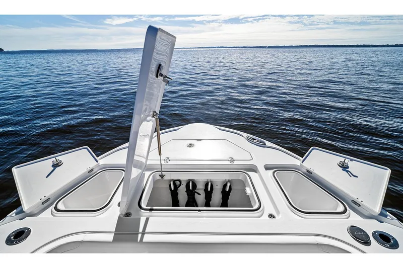 Slide: The Image of Manufacturer Provided Image: 2026 Blackfin 262 HB boat bow with open storage compartments on a calm lake. - 2