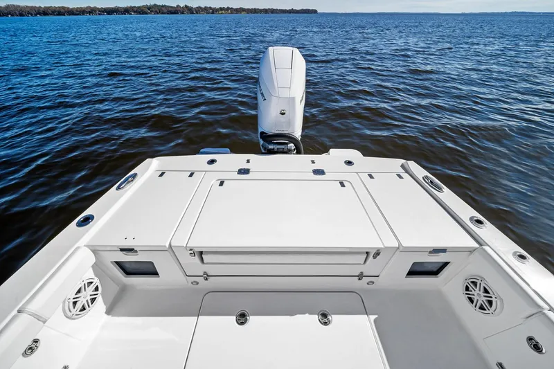 Slide: The Image of Manufacturer Provided Image: 2026 Blackfin 262 HB boat on water, showcasing spacious deck and powerful outboard motor. - 7