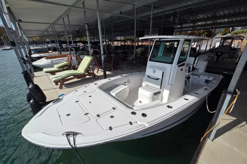 Slide: The Image of 2026 Blackfin 262 HB boat docked in a marina under a covered shelter. - 9