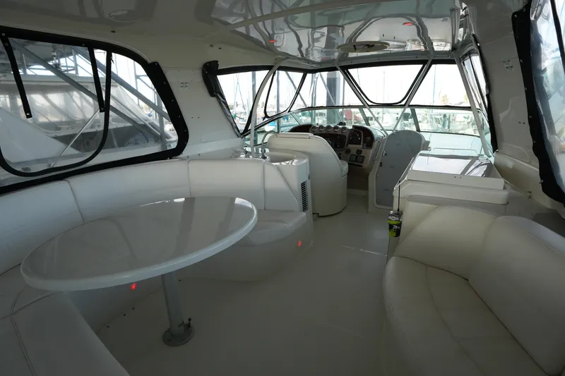 Slide: The Image of Interior of 2004 Carver 560 Voyager yacht with white seating and helm station. - 16