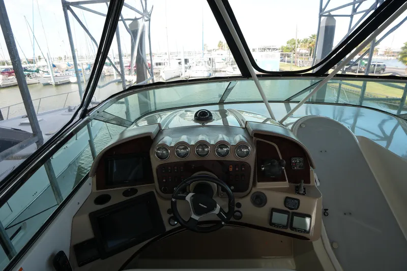 Slide: The Image of Interior helm of 2004 Carver 560 Voyager yacht with navigation controls and panoramic view. - 18