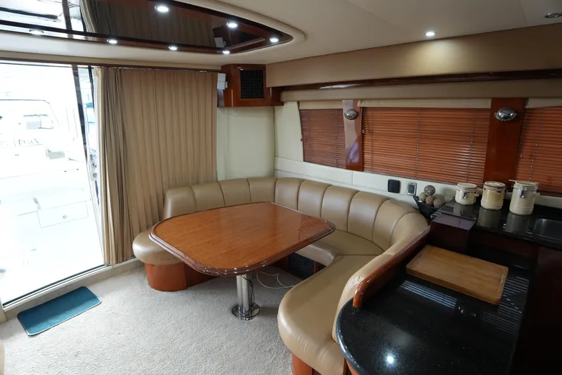 Slide: The Image of Luxurious interior of 2004 Carver 560 Voyager yacht with elegant dining area. - 24