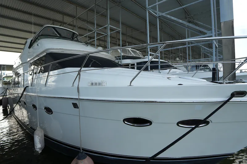 Slide: The Image of 2004 Carver 560 Voyager yacht docked in a covered marina. - 3