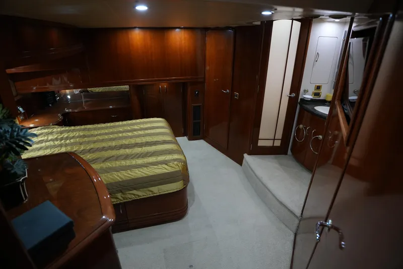 Slide: The Image of Luxurious interior of 2004 Carver 560 Voyager yacht with elegant wood finishes and cozy bedroom. - 41