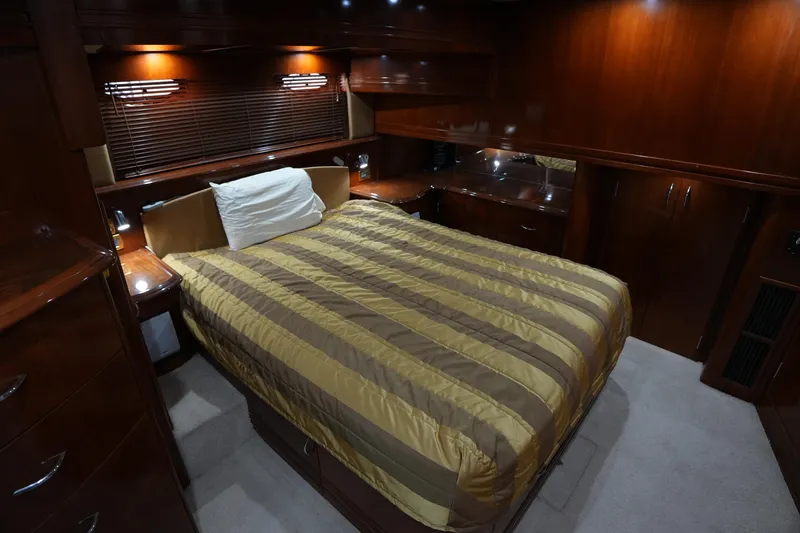 Slide: The Image of Luxurious bedroom interior of 2004 Carver 560 Voyager yacht with wood paneling. - 42