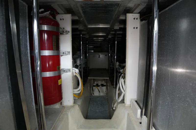 Slide: The Image of Engine room of 2004 Carver 560 Voyager with fire extinguisher and equipment. - 49