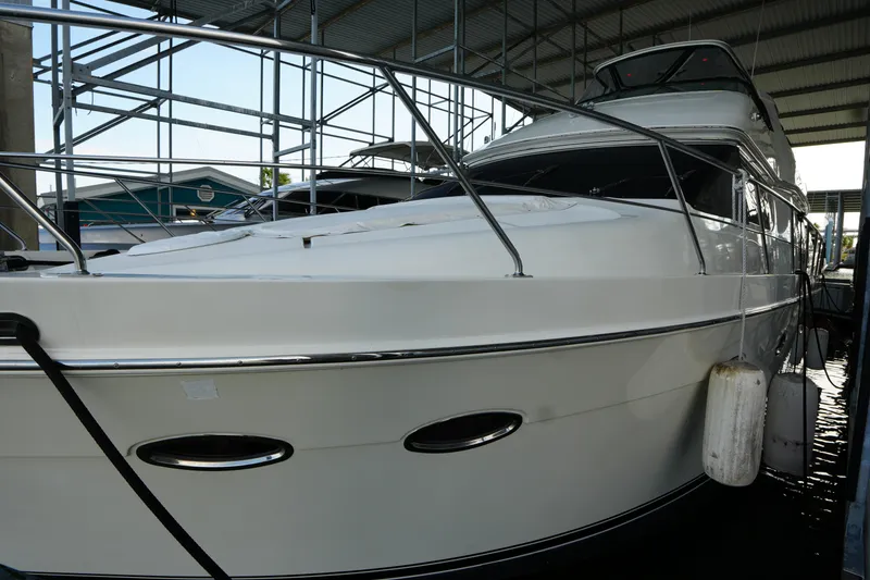 Slide: The Image of 2004 Carver 560 Voyager yacht docked in a covered marina. - 5