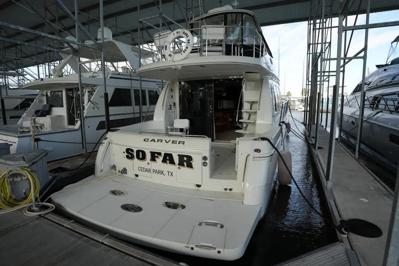 Slide: The Image of 2004 Carver 560 Voyager yacht docked, rear view, named "So Far" from Cedar Park, TX. - 1