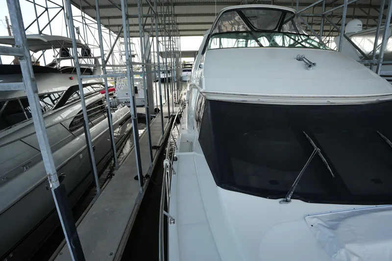 Slide: The Image of 2004 Carver 560 Voyager yacht docked in a covered marina. - 10