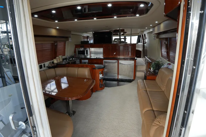Slide: The Image of Luxurious interior of a 2004 Carver 560 Voyager yacht with elegant seating and modern kitchen. - 23
