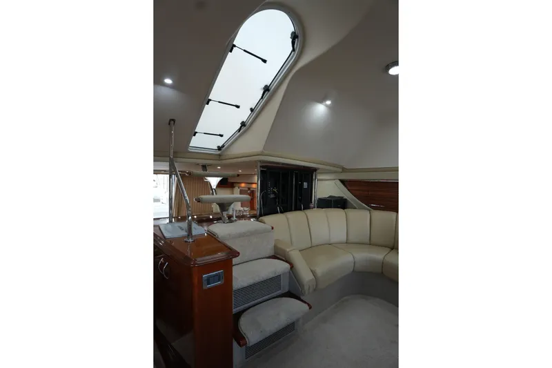 Slide: The Image of Luxurious interior of 2004 Carver 560 Voyager yacht with plush seating and skylight. - 27