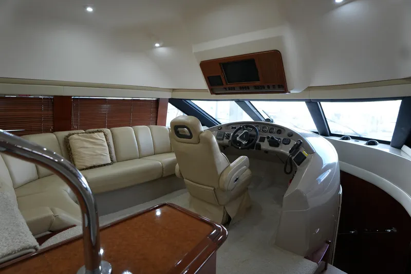 Slide: The Image of Luxurious interior of a 2004 Carver 560 Voyager yacht with plush seating and modern helm. - 28