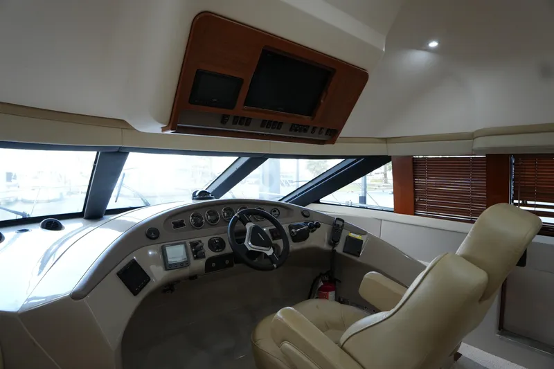 Slide: The Image of Interior cockpit of 2004 Carver 560 Voyager yacht with steering wheel and control panel. - 30