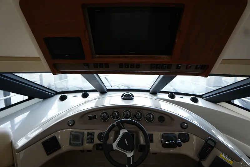 Slide: The Image of 2004 Carver 560 Voyager helm with steering wheel, gauges, and navigation equipment. - 31
