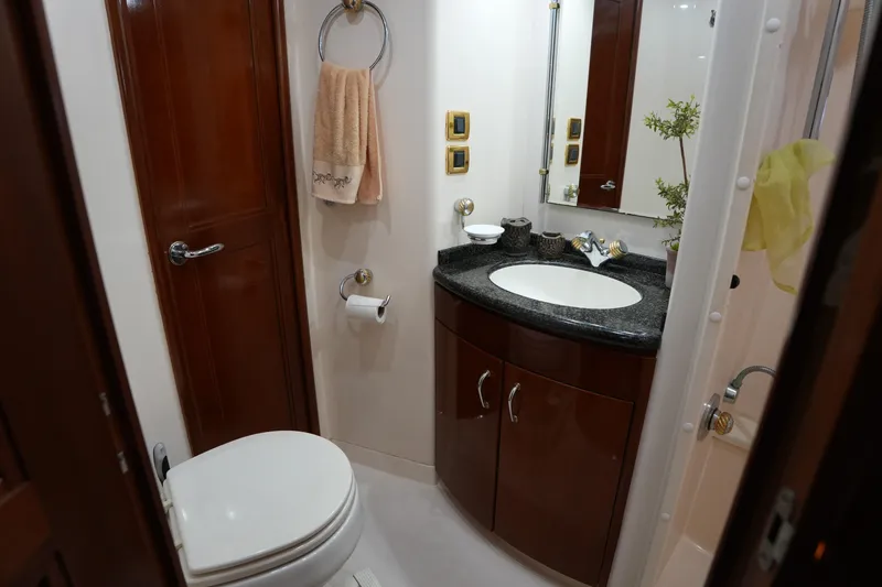 Slide: The Image of Luxurious bathroom in 2004 Carver 560 Voyager yacht with elegant wood cabinetry. - 38