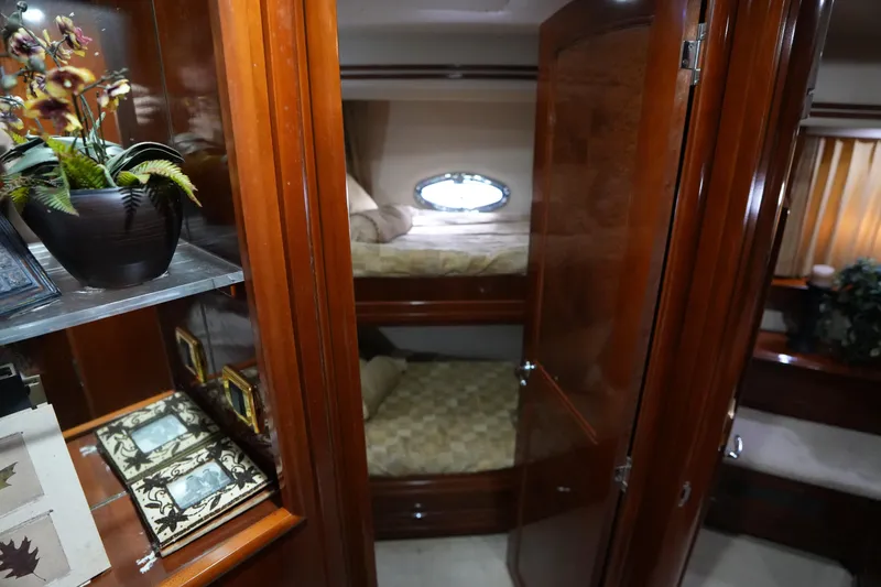 Slide: The Image of Luxurious interior of 2004 Carver 560 Voyager yacht with wooden cabinetry and cozy bunk beds. - 39