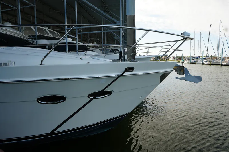Slide: The Image of 2004 Carver 560 Voyager yacht docked at marina, side view with railing and anchor. - 4