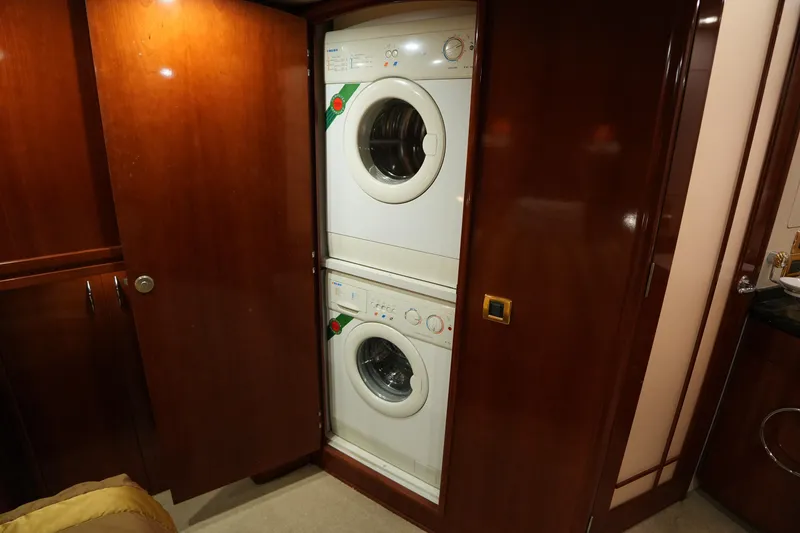 Slide: The Image of Stacked washer and dryer in 2004 Carver 560 Voyager yacht's wooden interior. - 46