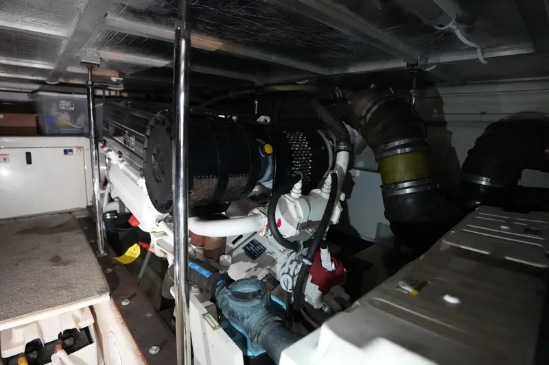 Slide: The Image of Engine room of a 2004 Carver 560 Voyager yacht, showcasing mechanical components. - 51