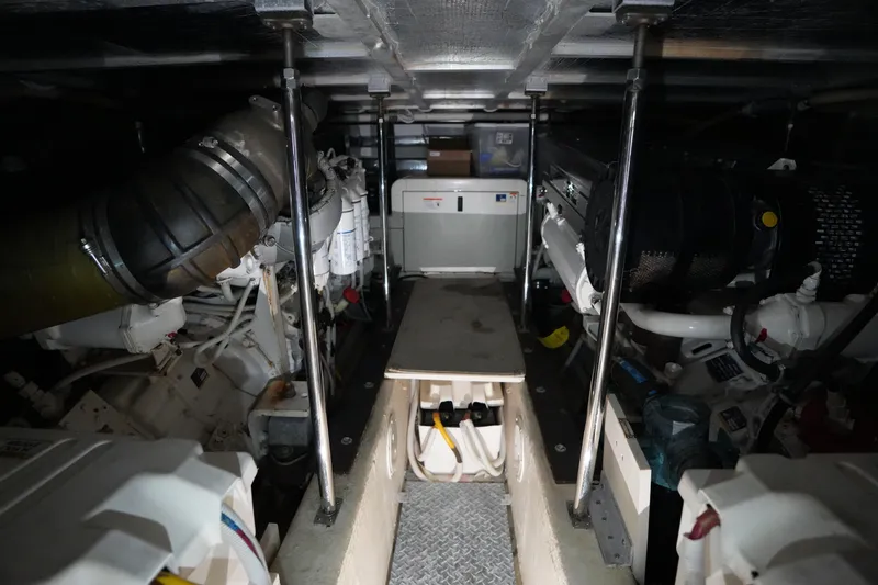 Slide: The Image of Engine room of a 2004 Carver 560 Voyager yacht, showcasing mechanical components. - 52