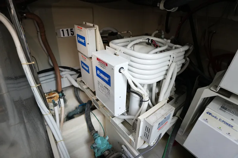 Slide: The Image of Engine room of 2004 Carver 560 Voyager with marine equipment and wiring. - 54