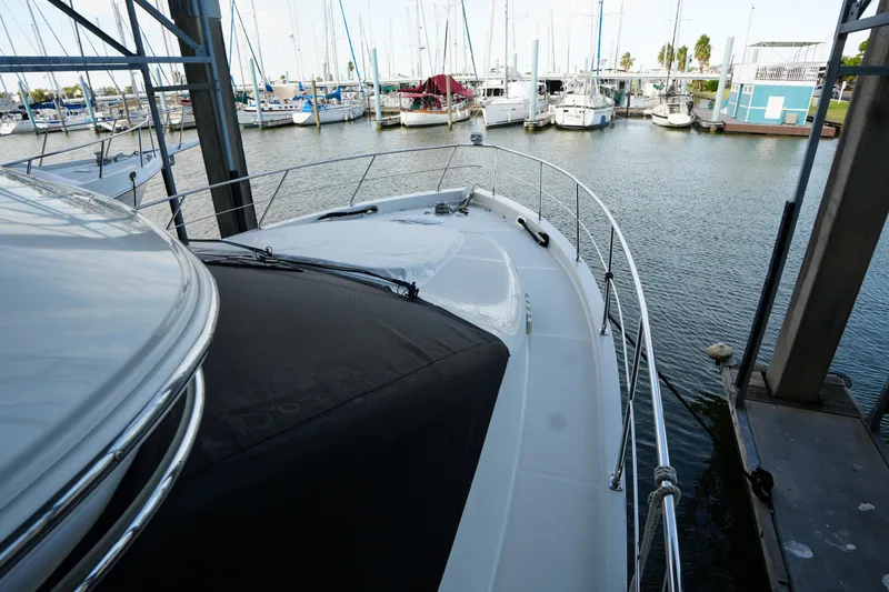 Slide: The Image of 2004 Carver 560 Voyager yacht docked in a marina with surrounding boats. - 9