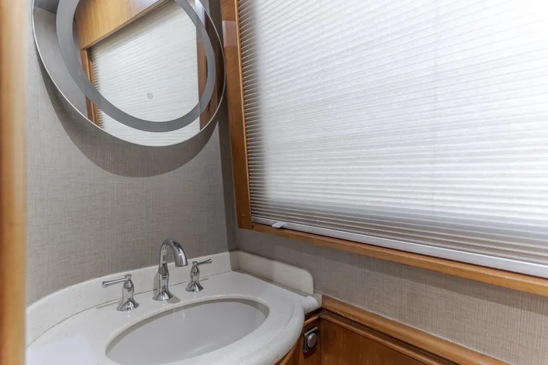 Slide: The Image of Bathroom sink area in 1997 Fobes Cooper Pilthouse with modern fixtures and circular mirror. - 16