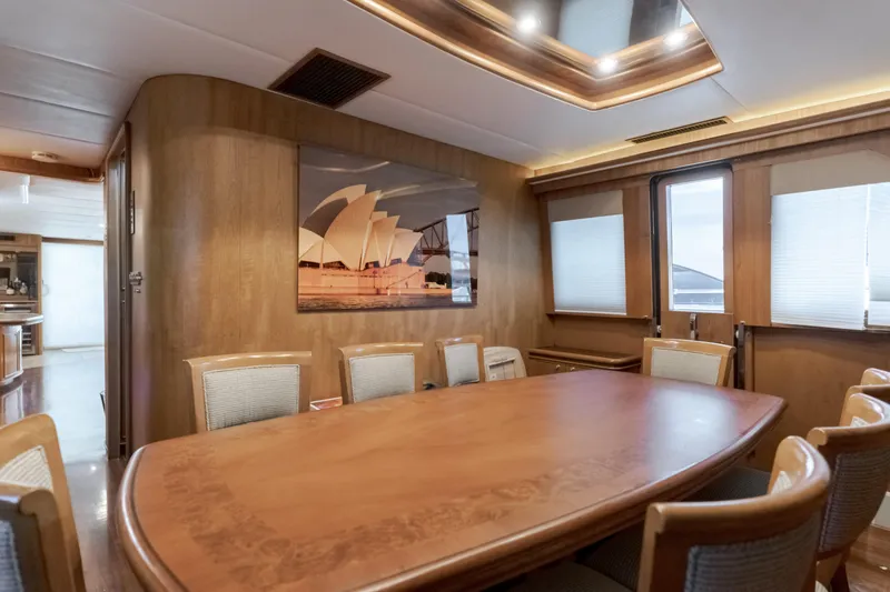 Slide: The Image of Luxurious dining area on 1997 Fobes Cooper Pilthouse yacht with wood paneling and large table. - 19